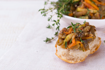 Vegetable ragout of eggplant, zucchini and carrots on slice of homemade bread