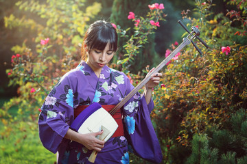 Japanese woman playing traditional shamisen