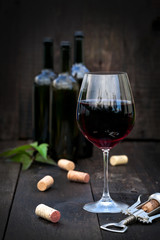 Glass of red wine on old wooden table