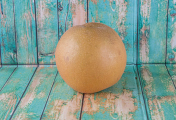 Asian pear, also known as Nashi pear over wooden background