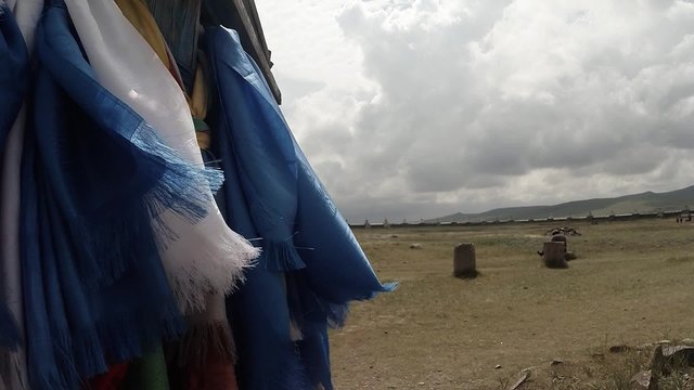 long prayer blue flags flutter in the wind at a Buddhist monastery in column
Erdene Zuu Buddhist monastery - one of the oldest monuments of Mongolia