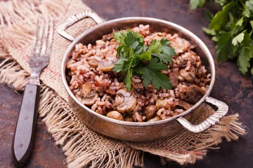 Photo sur Plexiglas Plats de repas Rice with mushrooms  and fresh parsley vintage saucepan.selective focus