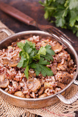 Rice with mushrooms  and fresh parsley vintage saucepan.selective focus
