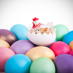 Chicken toy on easter eggs closeup
