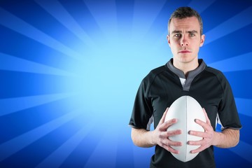 Composite image of a frowning standing rugby player 