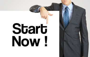 Businessman holding or showing banner with text Start Now
