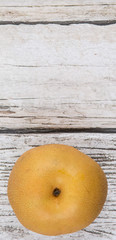sian pear, also known as Nashi pear over wooden background