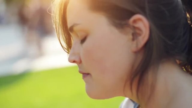 Woman putting on suncreen outdoors