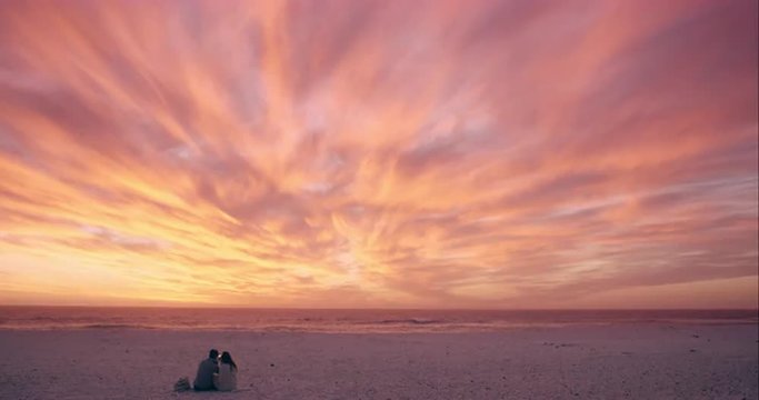 Happy romantic couple taking photograph of sunset using mobile phone camera wide  shot on RED DRAGON