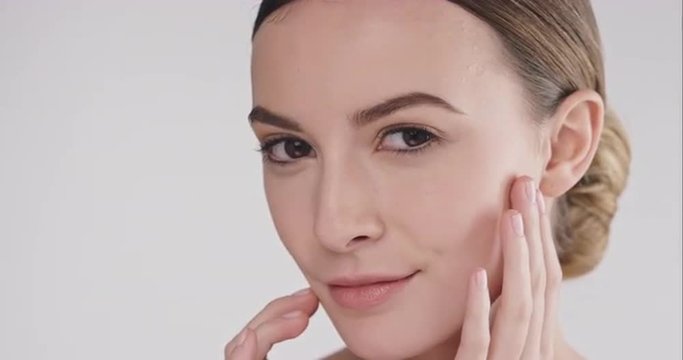Beauty portrait of woman touching beautiful face slow motion skincare concept on a grey background slow motion Red Epic Dragon