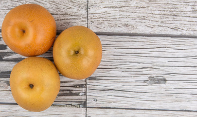 sian pear, also known as Nashi pear over wooden background
