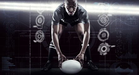 Fototapeta na wymiar Composite image of sportsman holding ball while playing rugby