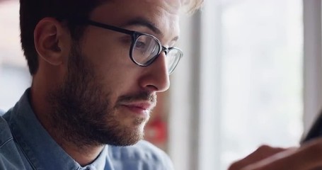 Man using digital display touchscreen tablet ipad device in cafe - Powered by Adobe
