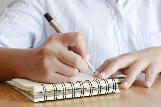 Writing Notes on a Memo Pad