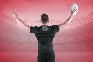 Composite image of rugby player celebrating with the ball