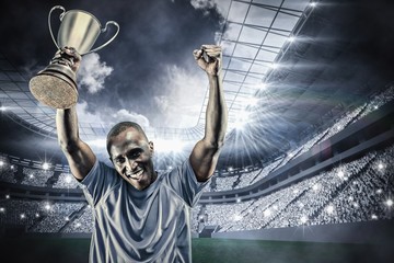 Composite image of portrait of happy sportsman cheering