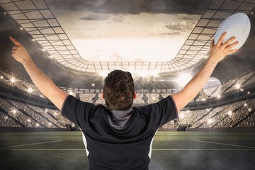 Fototapeta na wymiar Composite image of back turned rugby player gesturing victory