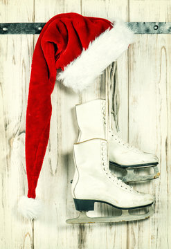 Red Santa Claus hat and ice skates. Vintage christmas decoration
