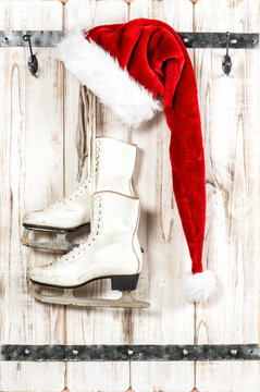Christmas decoration. Red Santa Claus hat and ice skates