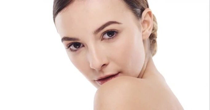 Beauty portrait of woman touching beautiful face in slow motion skincare concept on a white background 