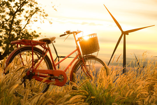 beautiful landscape image with Bicycle and Windturbine farm at s