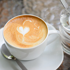 Cappuccino or latte coffee with heart shape and brown sugar