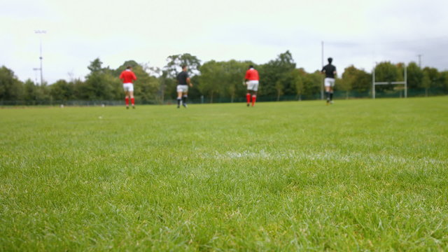 Rugby players practising passing together
