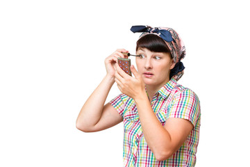 Housewife in a cloth dye eyelashes on white background