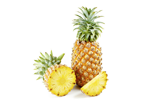 Pineapple with slices on  white background.