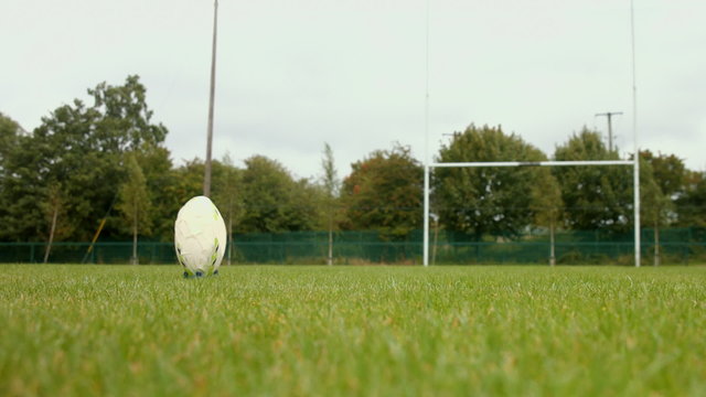Close up of a rugby player kicking a rugby ball
