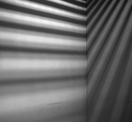 Lights and shadows falling on corner of concrete wall
