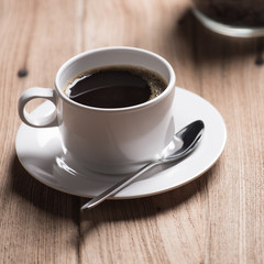 Coffee cup and saucer on a wooden table.