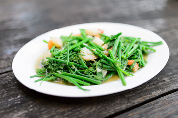 Fried bitter gourd leaf with oyster sauce , Thai style food