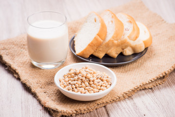 Soybeans and soy milk in a glass with fresh buns. selective focu