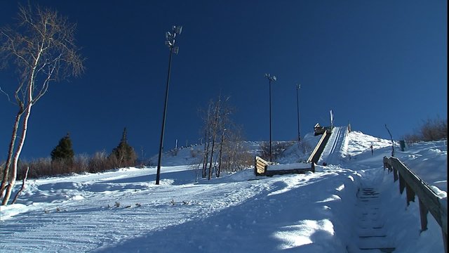 Low shot as jumper comes of lower ski jump