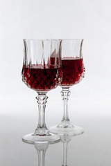 Two partially filled wine glasses