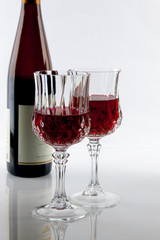A wine bottle and Two partially filled glasses