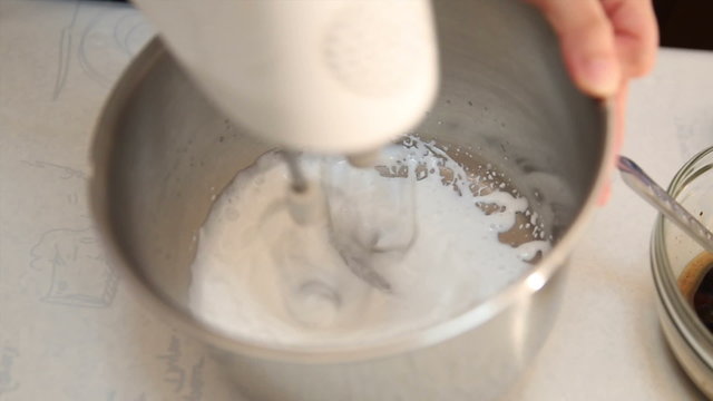 Video of electric mixer whipping cream from liquid milk