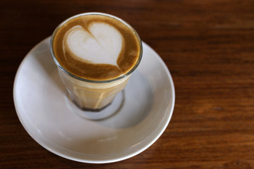 heart drawing on latte art coffee on wood table background