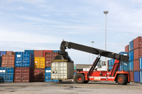 Crane lifting up container in the cargo at the port