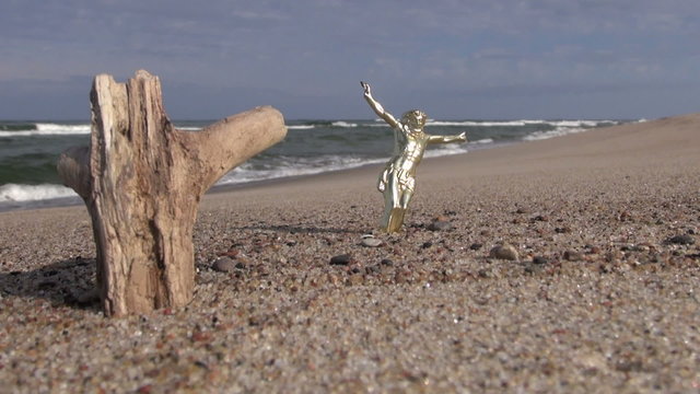 Seascape with crucifix and wooden rustic log in the sand