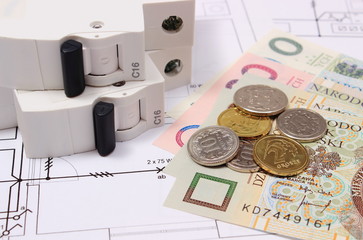 Electric fuse and money on electrical drawing, energy concept