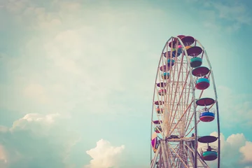 Deurstickers Ferris wheel on cloudy sky background vintage color © imnoom