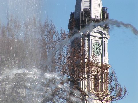 An artistic shot of the City Hall tower through fountain spray in Center City Philadelphia.