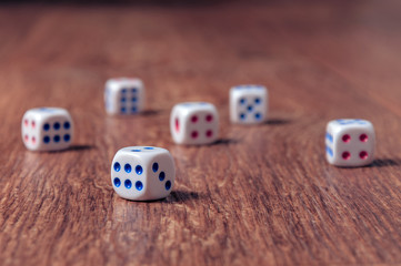 Rolling three dice on a wooden desk