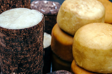 Cheese wrapped in fir bark and wheels of smoked cheese. Specific area Brasov, Romania.