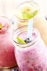 Assorted fruit shakes on white table
