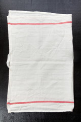 white kitchen towel on a dark background. space for writing text