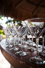 Empty Martini glasses setting at tropical palapa