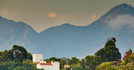 France, Menton, 01 09 2015: 4k timelapse Villa on the rock, mooving clouds, sunset, orange clouds